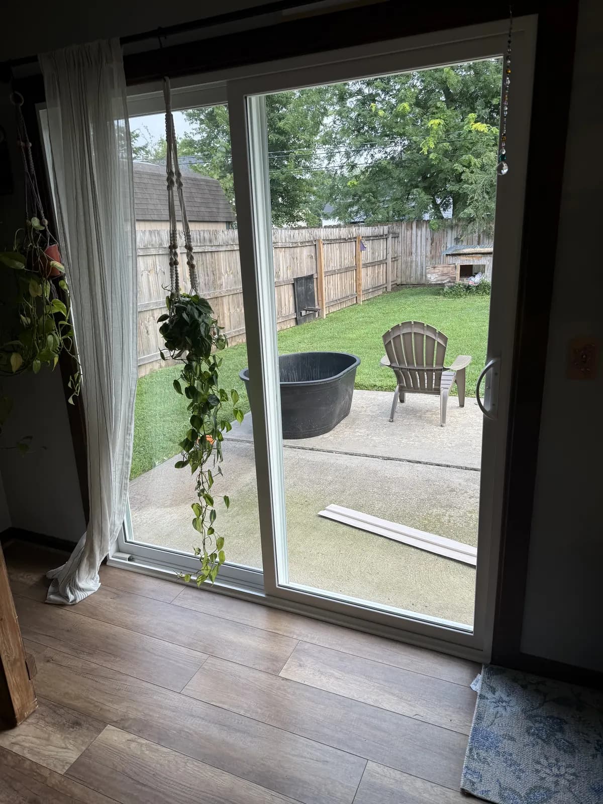 The new sliding patio door from inside, opening the room onto the back yard